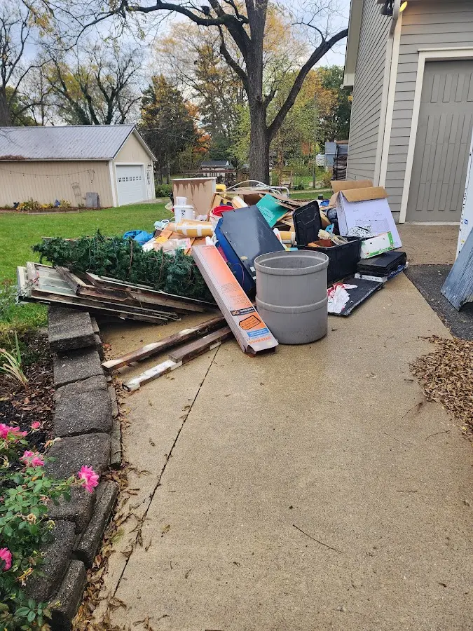 Dumpster being loaded with debris for Estate Cleanout Dumpster Rental in Otis Orchards-East Farms
